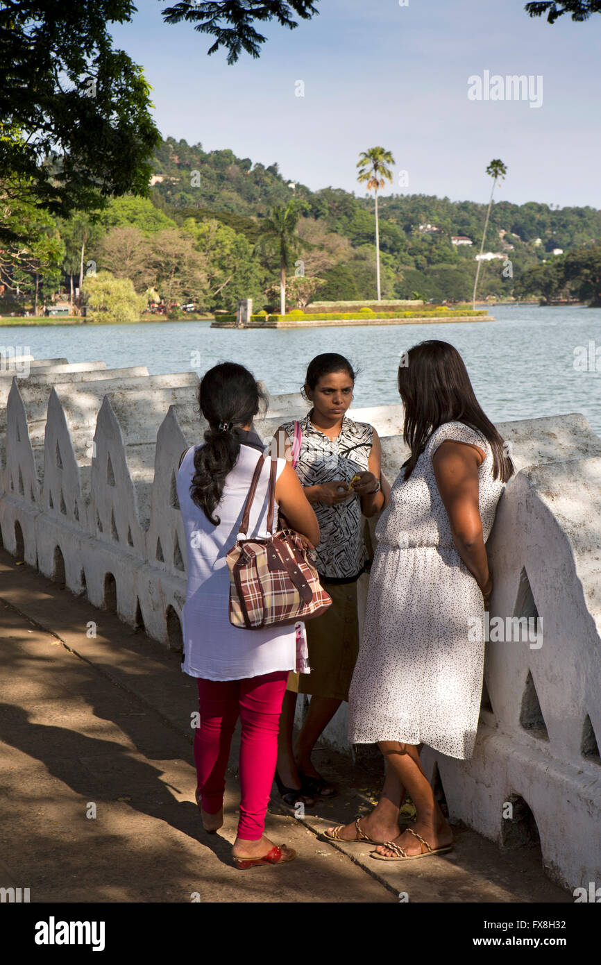 Sri Lanka, Kandy, Dalada Vidiya, woman chatting beside Kiri Muhuda Lake Stock Photo