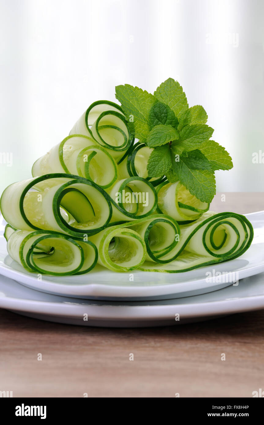 Salad cucumber ribbons twisted in rolls with mint Stock Photo - Alamy