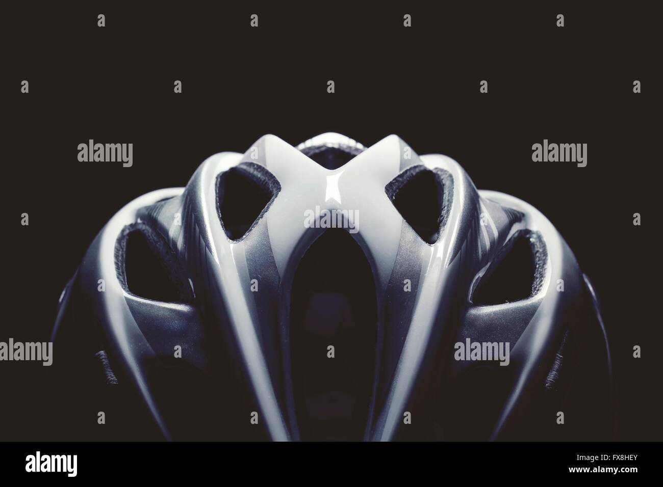 Bike helmet lighten from top on the black backround Stock Photo