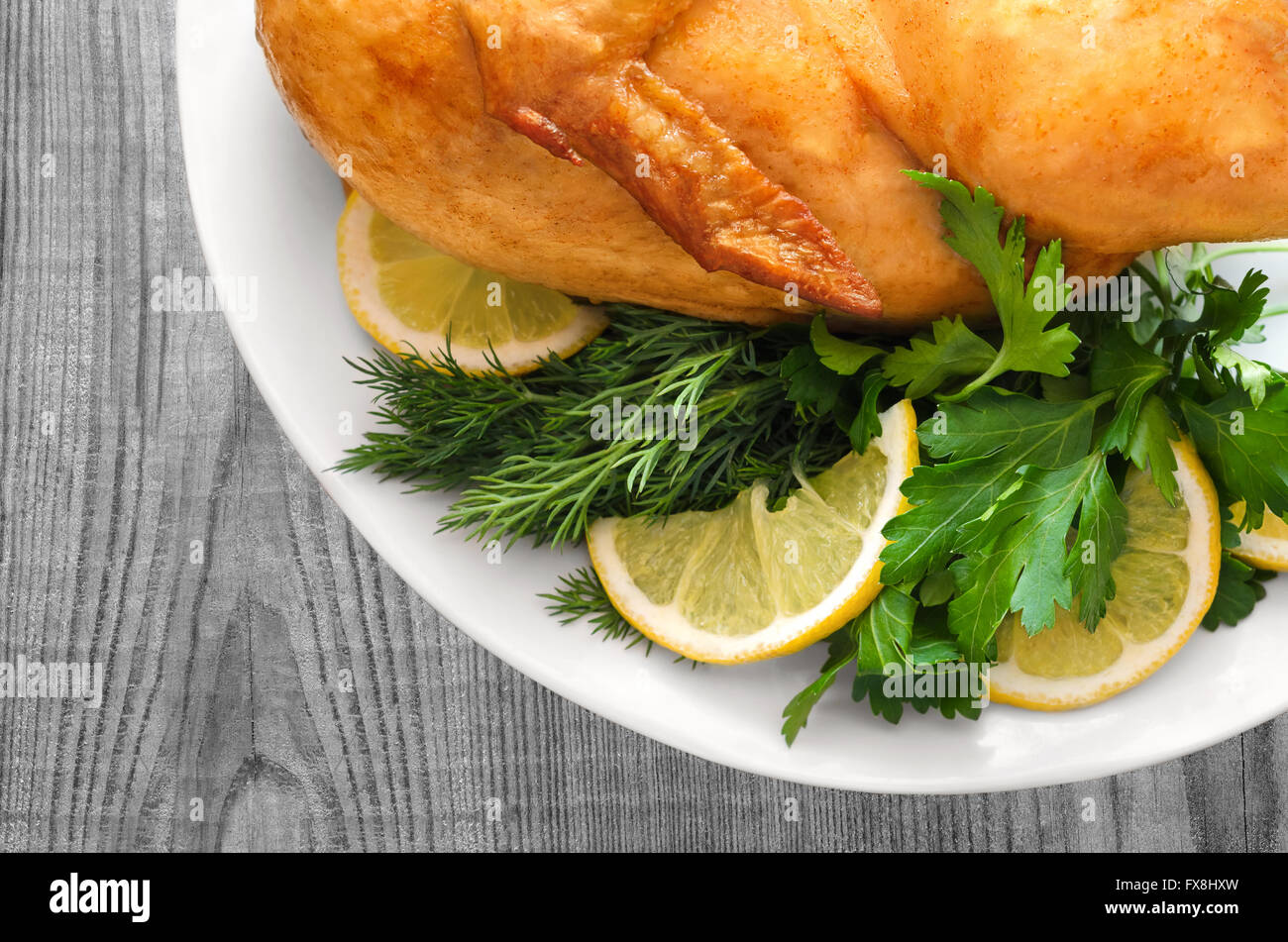 Roast chicken with parsley and lemon Stock Photo Alamy