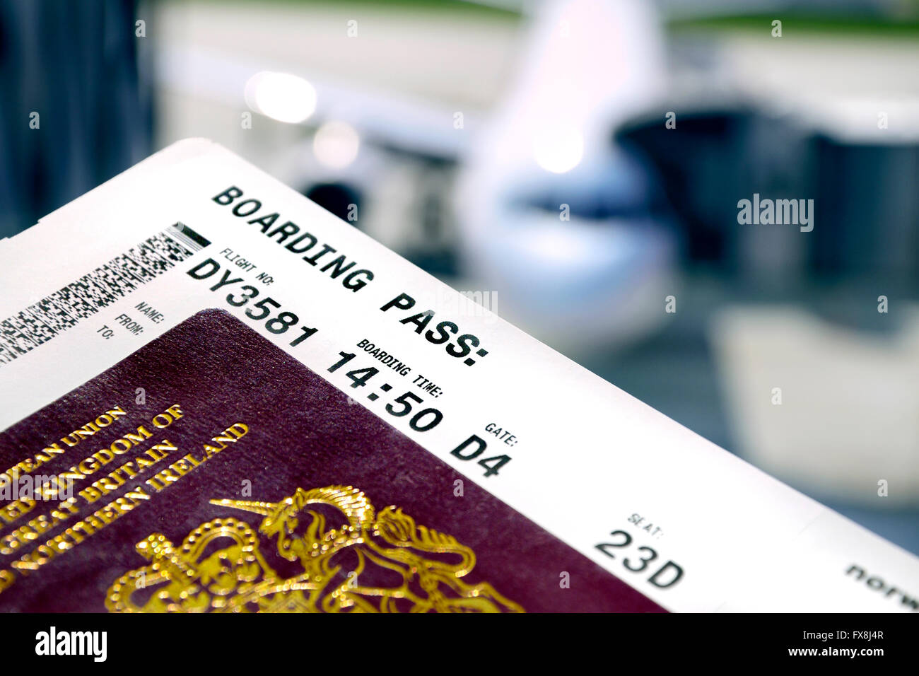 British Passport and boarding pass at the airport (Prague) Plane loading behind Stock Photo
