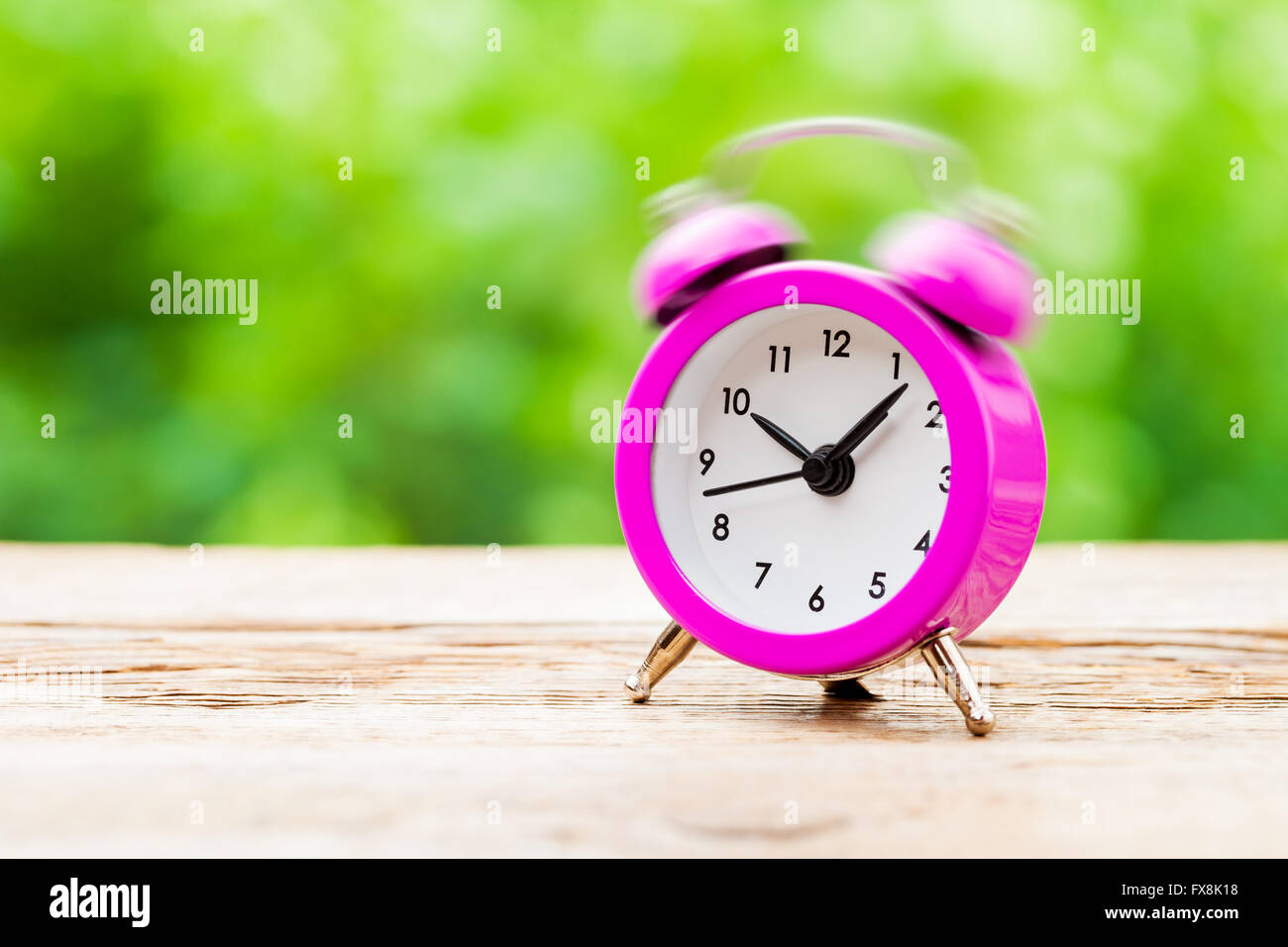 Ringing pink Alarm clock Stock Photo