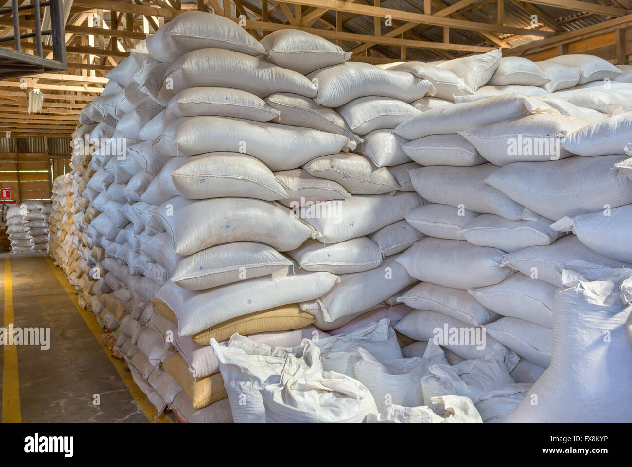 Stack of white bags at warehouse Stock Photo - Alamy