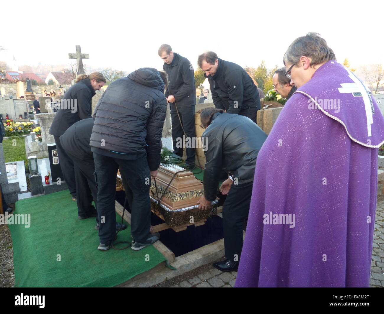 Lowering casket into grave at country funeral Stock Photo