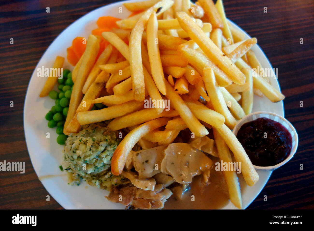 A turkey dinner with french fries Stock Photo