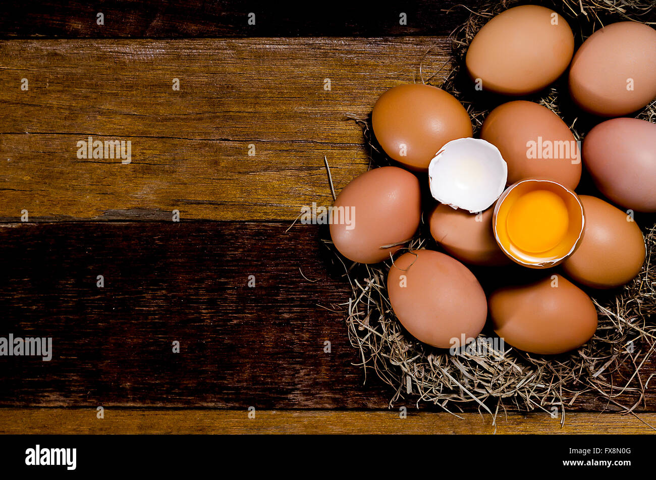 Eggs in nest on dark vintage wooden background.Top view Stock Photo - Alamy
