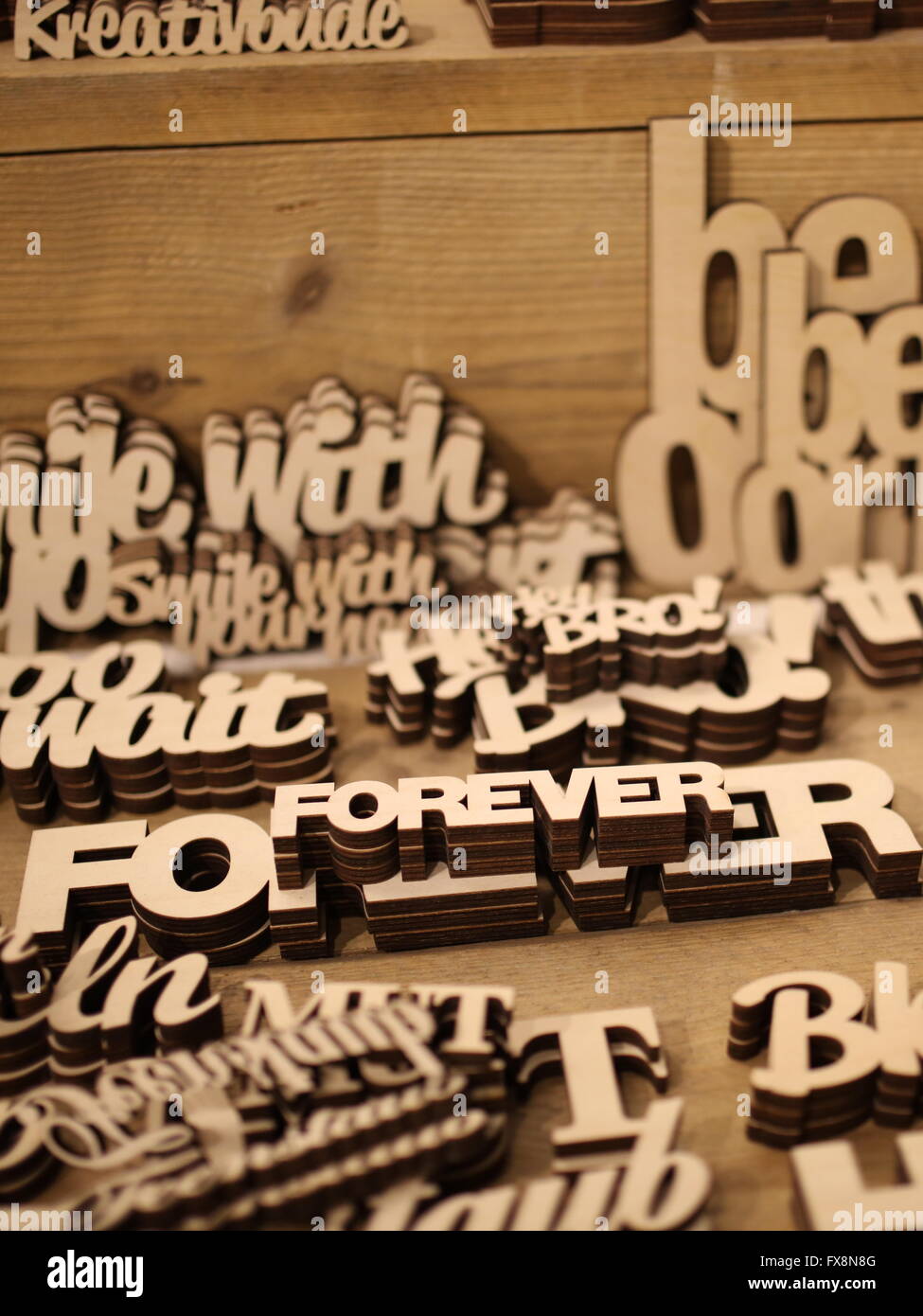 Writing carved out of wood in selective focus Stock Photo