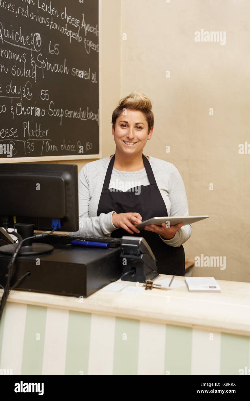 Tablet are a deli owner's best friend Stock Photo - Alamy