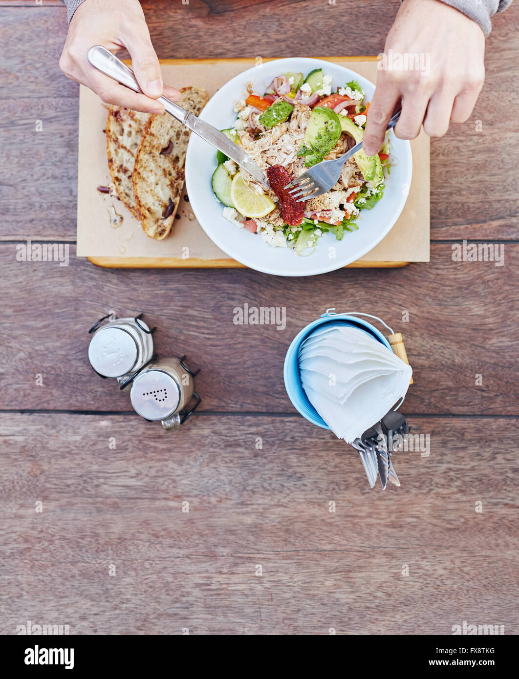 Person using cutlery to eat a fresh chicken salad Stock Photo Alamy