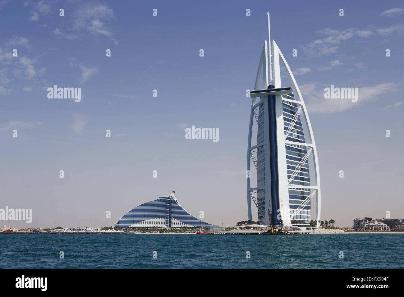 Burj Al Arab from the sea with Jumeriah Beach Hotel on the left hand side. Stock Photo
