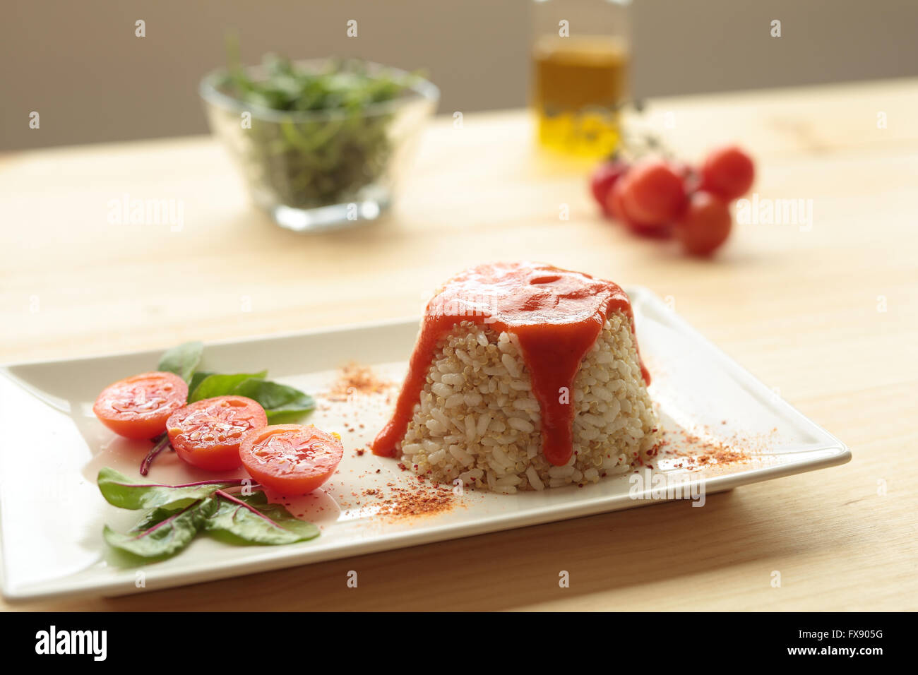 Cuban style rice decorated with cherrys tomatoes and a green leaves Stock Photo