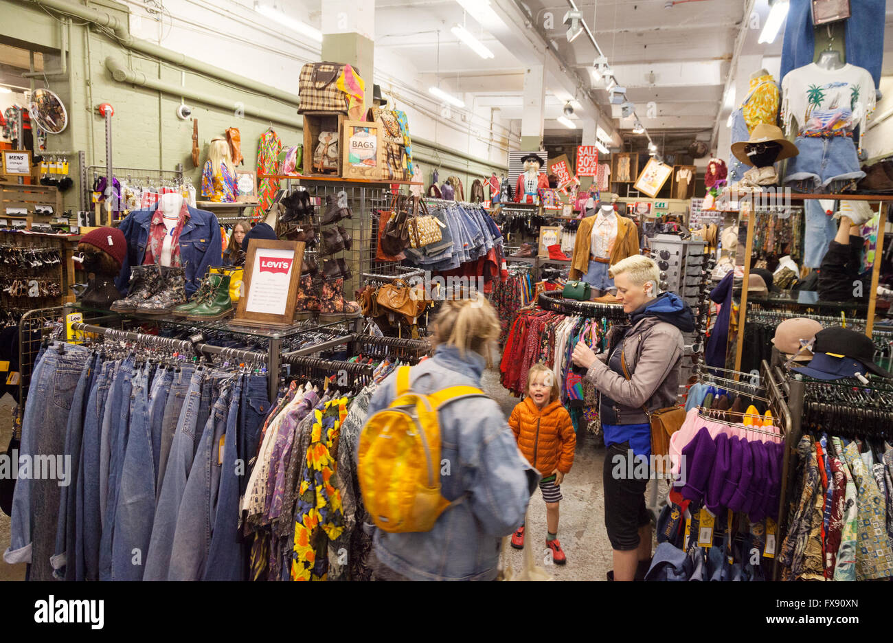 People shopping, Beyond Retro vintage clothing clothes shop, Cheshire Street, Spitalfields, London UK Stock Photo