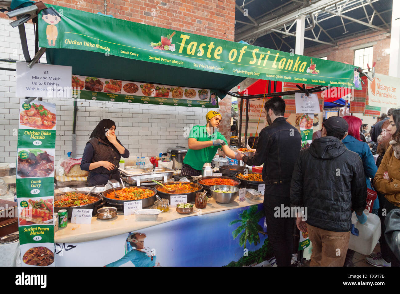 People buying food, Brick Lane Sunday Upmarket, Brick Lane, Spitalfields, East End, London UK Stock Photo