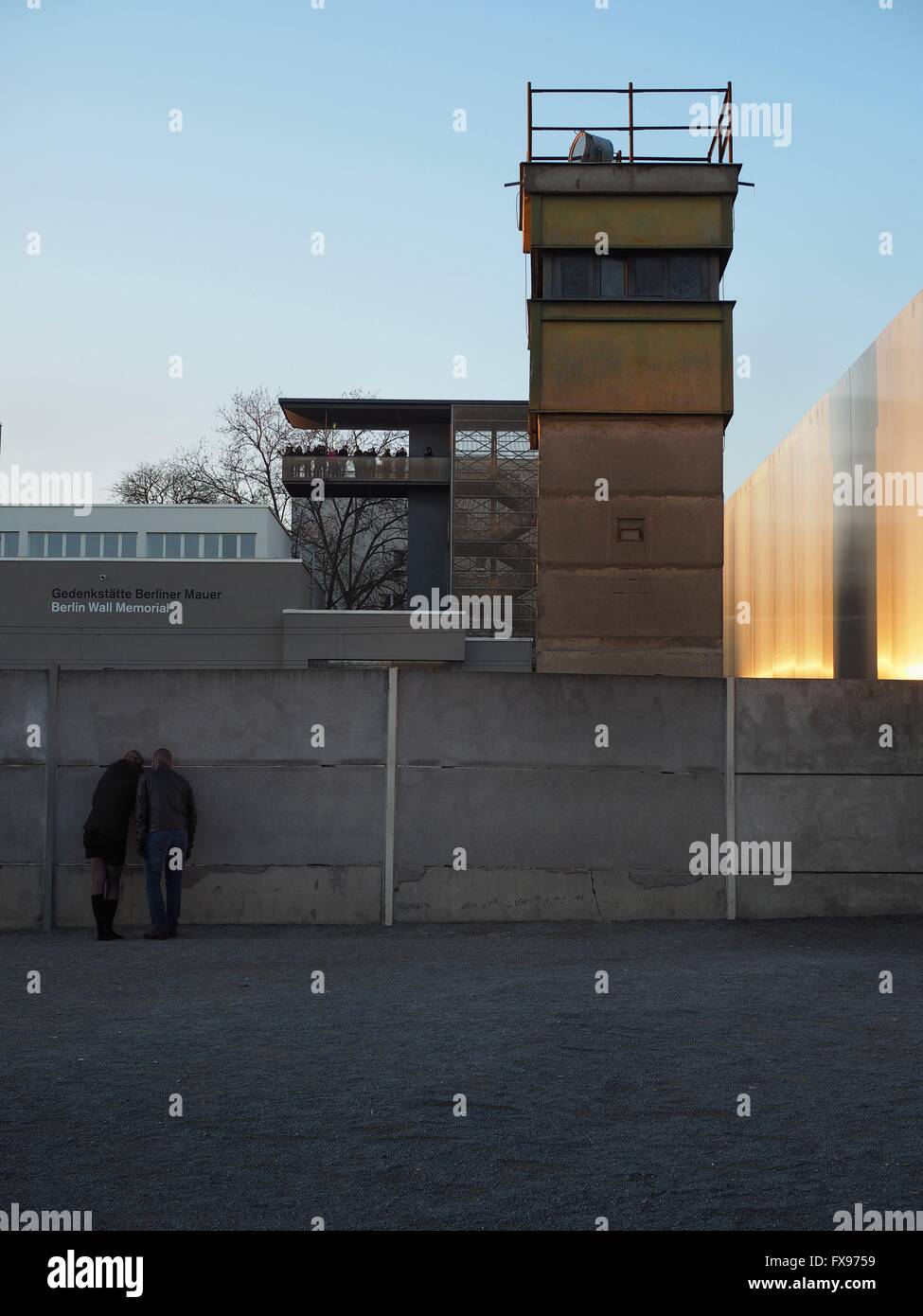 Visitors are looking trough a whole in a part of the wall at the Berlin Wall Memorial in Berlin at Bernauer Straße on December, 30, 2015. Photo: Wolfram Steinberg/dpa Stock Photo