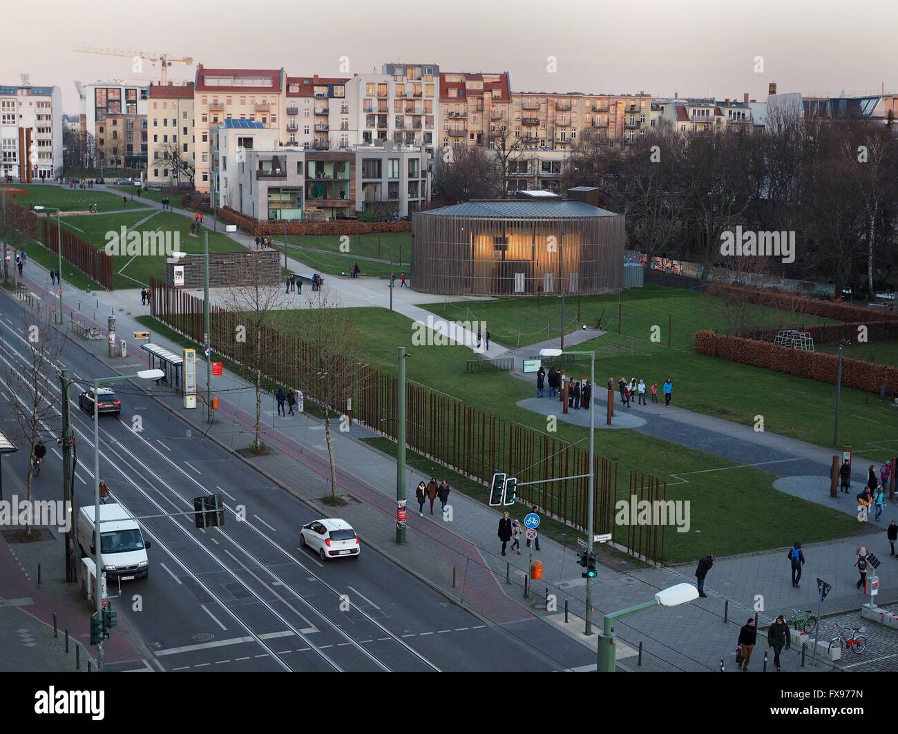 People walk next to and on the terrain of the Berlin Wall Memorial in Berlin at Bernauer Straße on December, 30, 2015. The photo was taken from the visitors platform of the Berlin Wall Memorial. Photo: Wolfram Steinberg/dpa Stock Photo