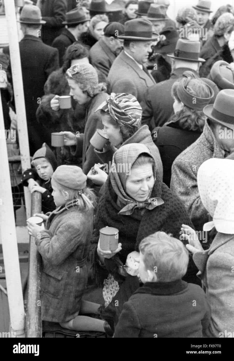 The Nazi propaganda image depicts volksdeutsche (ethnic German) refugees from Yugoslavia that are provided with warm drinks after they arrived on the steamer 'Uranus' in Pressburg (today: Bratislava/Slovakia). The photo was taken in April 1941. Fotoarchiv für Zeitgeschichtee - NO WIRE SERVICE - Stock Photo