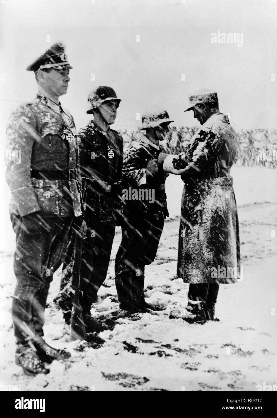 The Nazi propaganda image depicts the awarding of the Iron Cross to soldiers of the German Wehrmacht for their service in the partisan combat in Yugoslavia. The photo was taken in January 1944. Since summer 1942, the name 'partisan' had been prohibited by the Germans and replaced by the name 'Banden' (gangs), 'Banditen' (bandits), and 'Bandenbekaempfung' (fighting gangs). Fotoarchiv für Zeitgeschichtee - NO WIRE SERVICE - Stock Photo