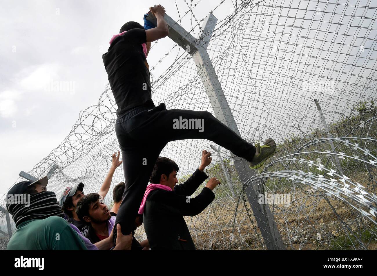 Idomeni, Greece. 13th April, 2016. Hundreds of migrants have tried today to break through the barrier that divides them from Macedonia , the police responded with tear gas, rubber bullets and sound bombs after the migrants have managed to break through the fence. dozens injured and intoxicated by tear gas.    Credit Credit:  Danilo Balducci/Sintesi/Alamy Live News Stock Photo