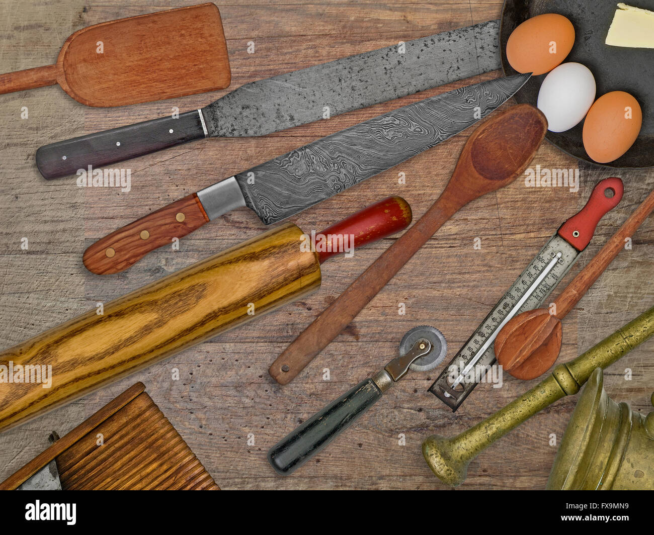 vintage bakery shop tools and utensils over stained wooden table Stock Photo