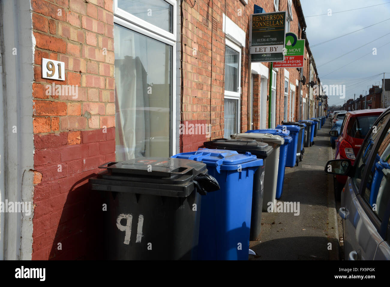 Household waste collection bins are a permanent sight on the footpath in Havelock  Road, Kettering, Northamptonshire. Stock Photo