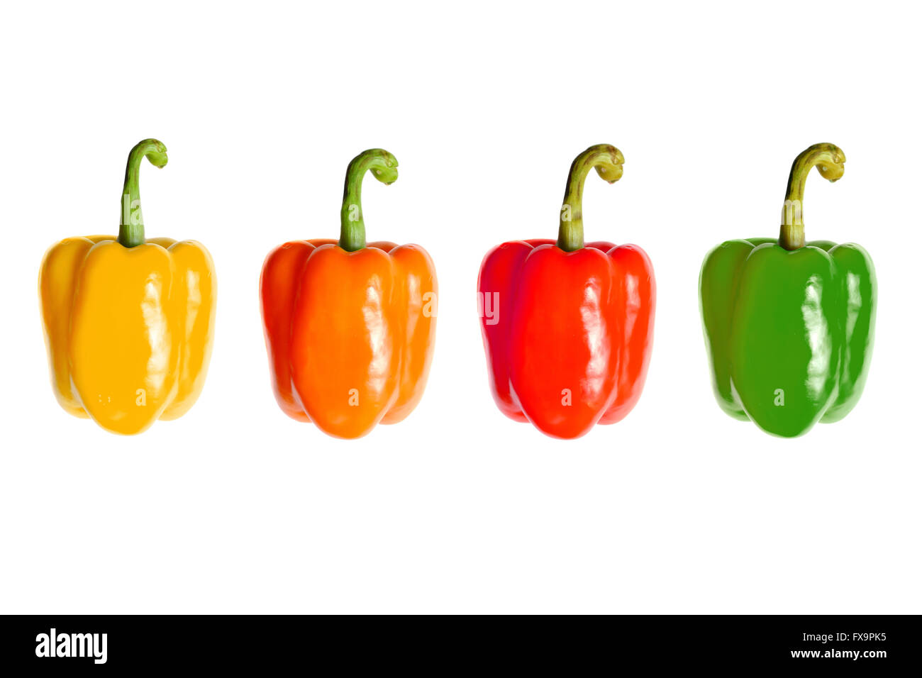 Four different coloured peppers photographed against a white background. Stock Photo