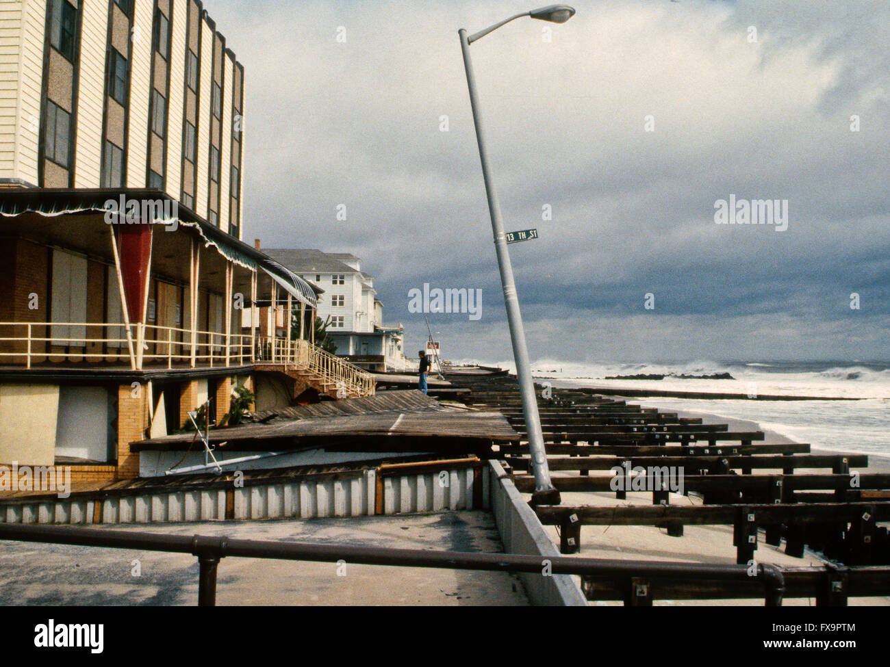 Ocean City, Maryland, USA, 28th September, 1985 The center of Gloria passed about 30 miles offshore eastern Maryland. In Ocean City, waves15 feet high severely damaged the boardwalk, washing sand and debris a block inland. It was a powerful Cape Verde type hurricane with winds reaching 92 mph along the Chesapeake Bay Bridge Tunnel in Virginia and gusts to 89 mph  in Ocean City.  High waves in Maryland eroded beaches, wrecked dunes, and damaged oceanfront buildings and boardwalks. The boardwalk in Ocean CIty the morning after Gloria passed by.  Credit: Mark Reistein Stock Photo