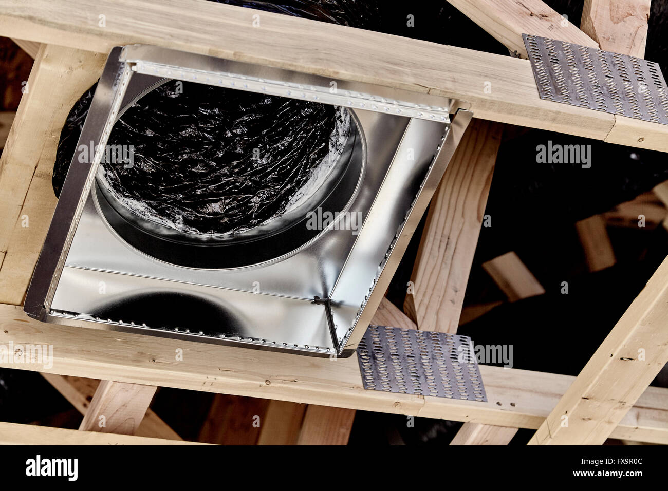 Framed home showing installation of air conditioner and heating duct