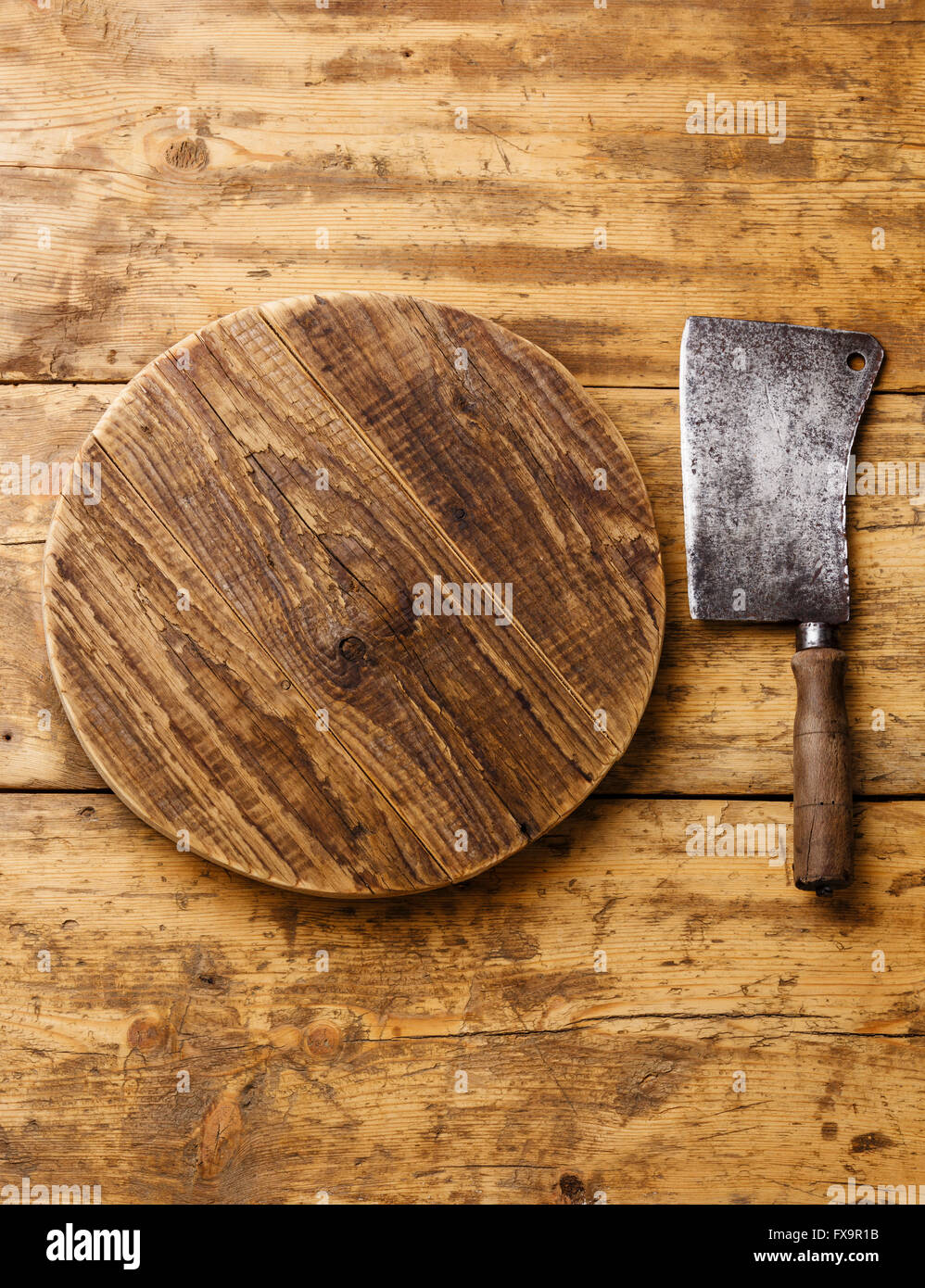 Butcher Meat cleaver and Chopping board block on wooden background Stock Photo
