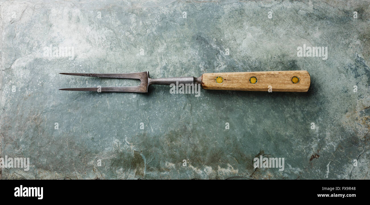 Meat fork wooden handle on gray stone slate background Stock Photo