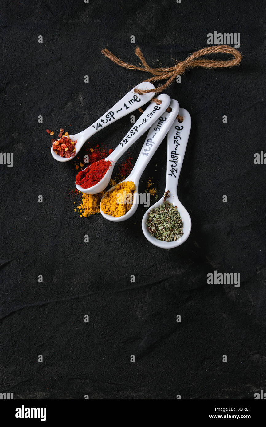 https://c8.alamy.com/comp/FX9REF/assortment-of-ground-colorful-spices-in-white-different-ceramic-measuring-FX9REF.jpg