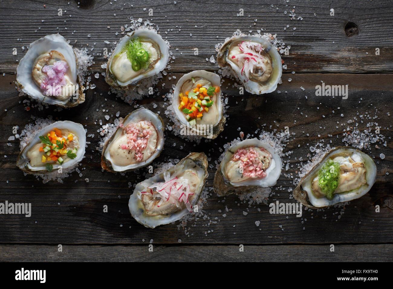 raw oysters on the half shell topped with an assortment of different