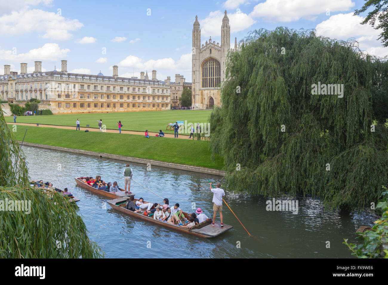 tourists punting in the summer on the River Cam in Cambridge with King's College Chapel in background Stock Photo