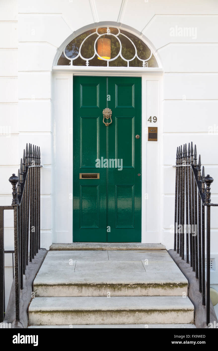 green Georgian era six-panel door with fanlight on Gibson Square in Islington, north London Stock Photo