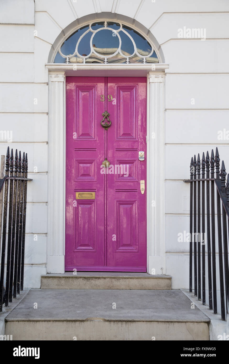 colourful magenta Georgian era front door with fanlight on Theberton Street in Islington, north London Stock Photo