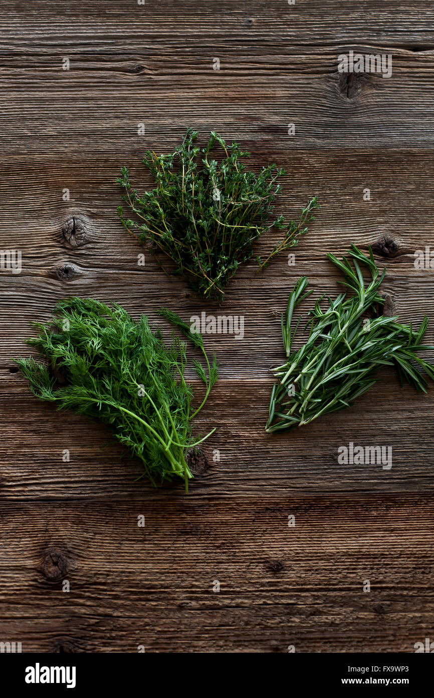 Rosemary, thyme and dill on a rustic wooden table Stock Photo Alamy