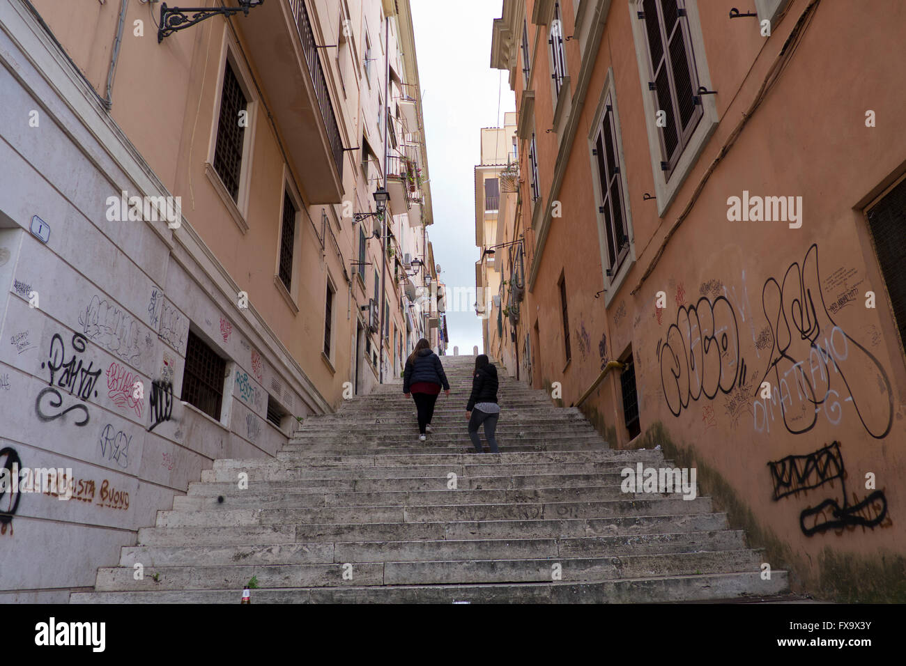 Two young women climb steep steps in Frascati in Italy Stock Photo