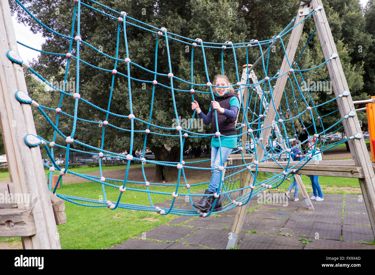 pre teen girl playing in park games in Frascati in italy Stock Photo - Alamy