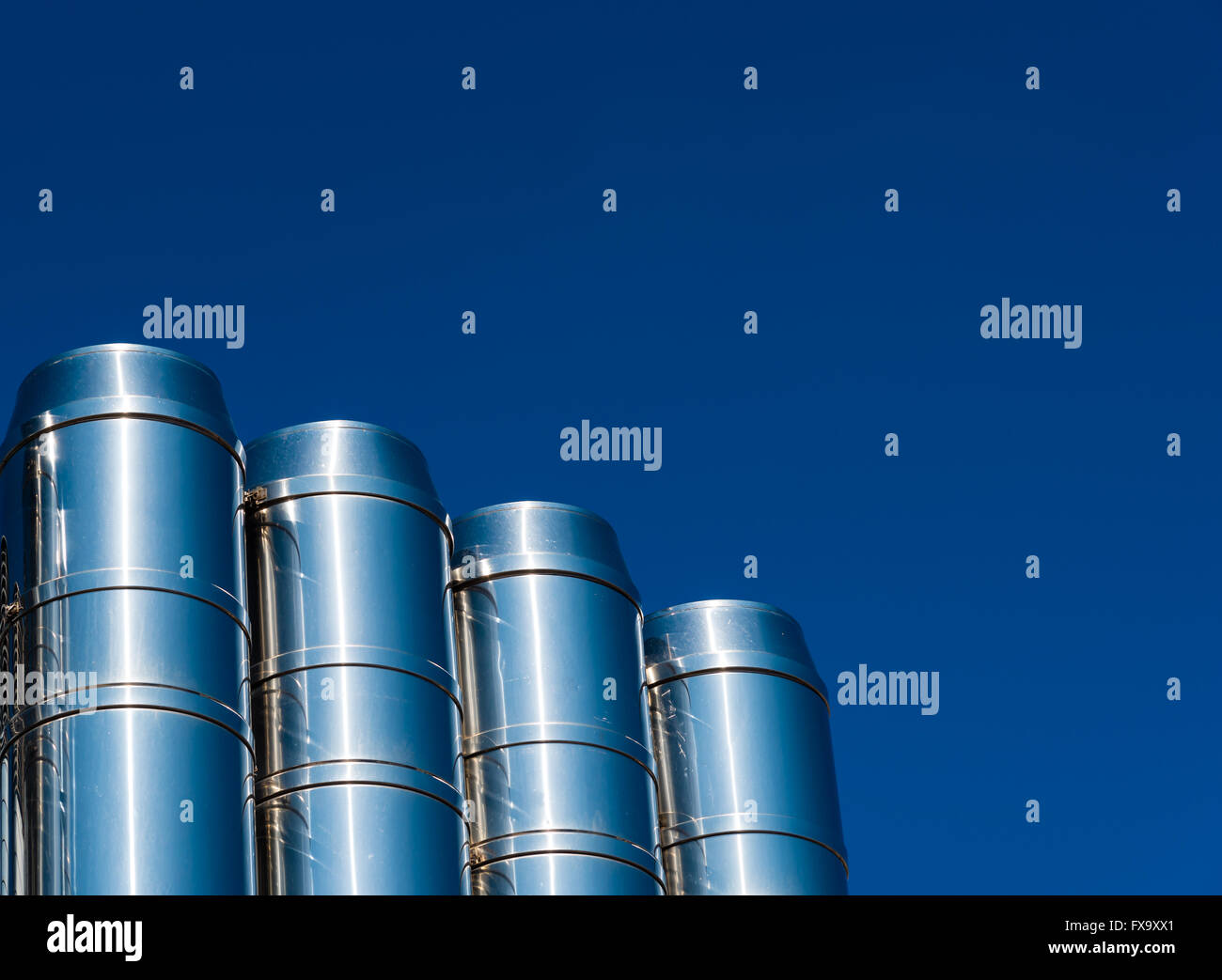 shiny chrome pipes against the blue sky Stock Photo