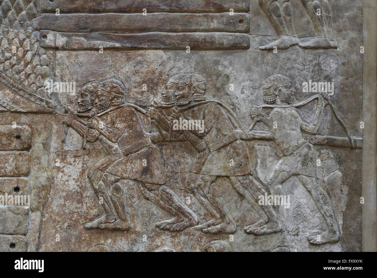 Slab. Transportation of timber (cedars of Lebanon). Men are pulling a load with a rope. Palace of Sargo II. Khorsabad, Iraq. Stock Photo