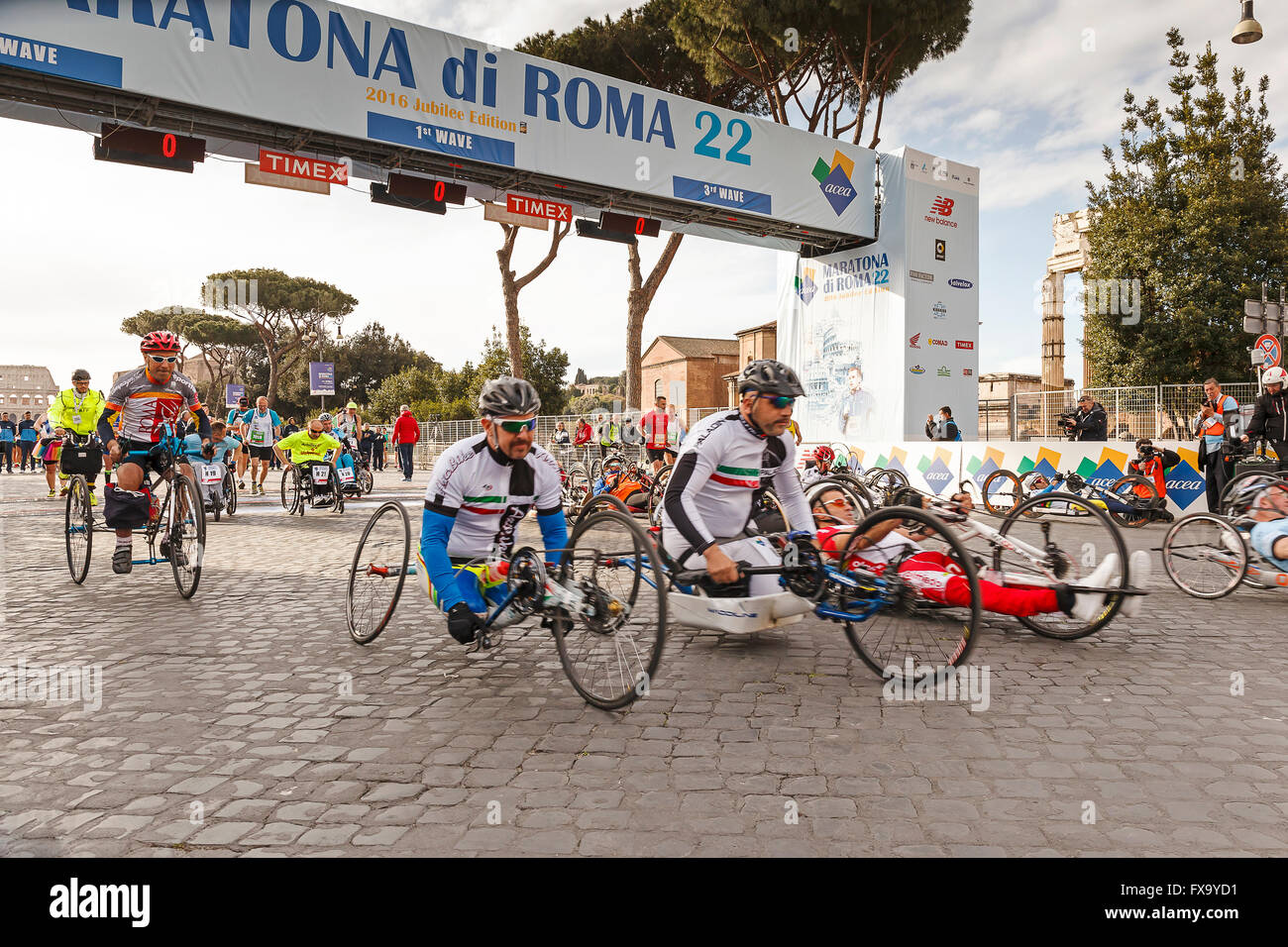 Disabled athletes of the race hand bikes. Rome, Italy - April 10, 2016: the  race Athletes hand bike at the start of the marathon Stock Photo - Alamy