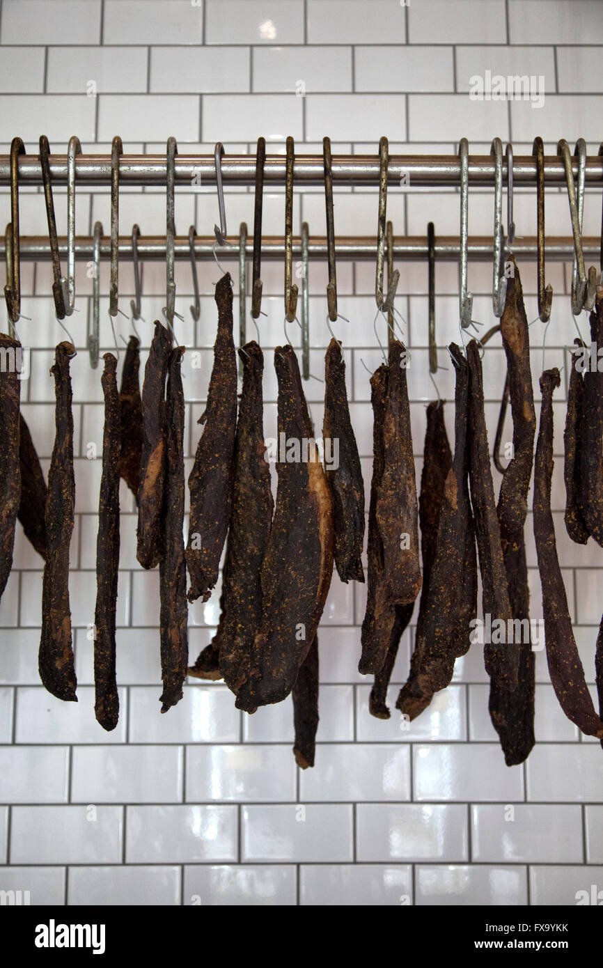 Cured biltong hanging from meat hooks Stock Photo - Alamy