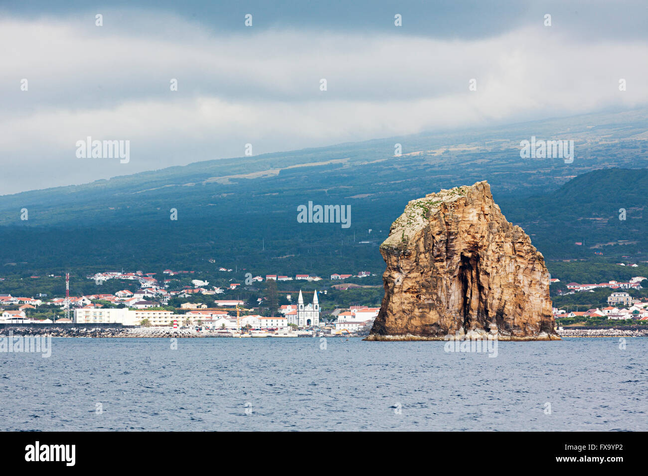 Large monolithic rock at the harbor entrance of Horta, Faial, Azores Stock Photo
