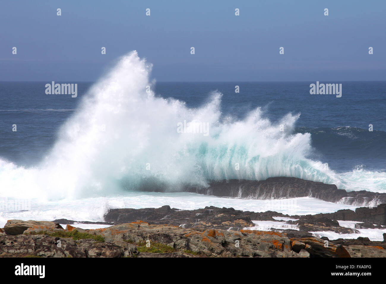 wave hitting rocks in ocean Stock Photo Alamy