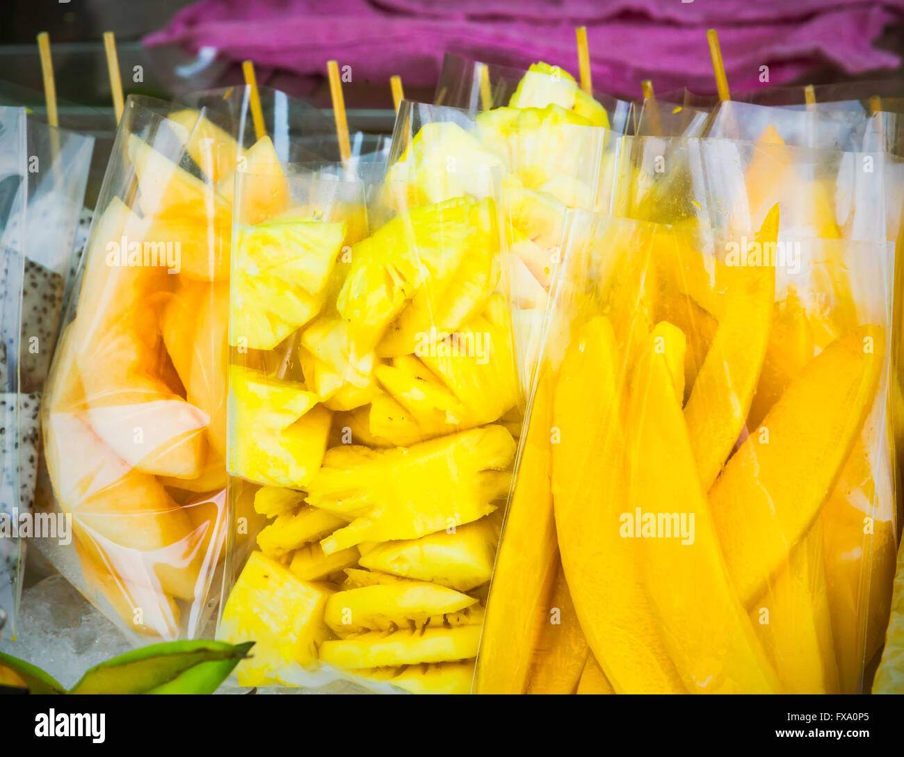 Thailand street food including cantaloupe, pineapple and mango in plastic  bag ready for sale. Bangkok, Thailand. Selective focus Stock Photo - Alamy