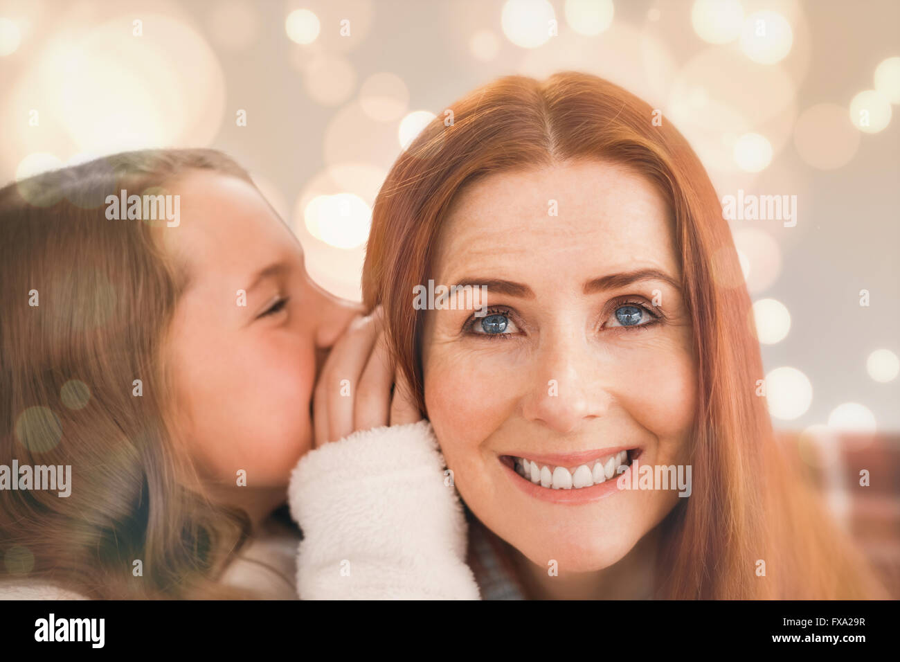 Composite image of mother and daughter telling secrets Stock Photo