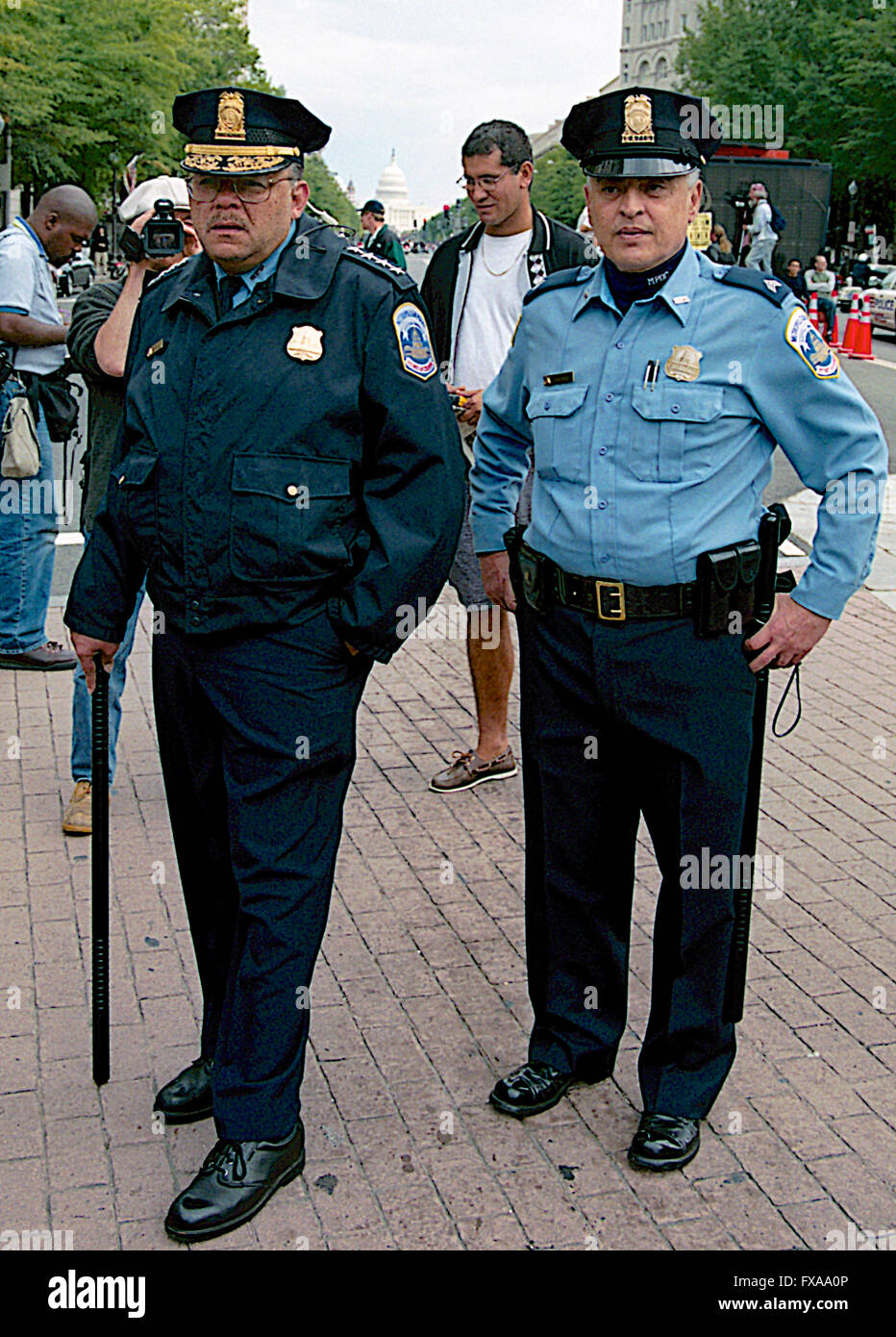 Washington, DC., USA, 20th April, 2002 Immigration rights protest march  in Washington DC.  DC. police Chief Charles Ramsey carrying his riot stick and his Public information officer, Sergeant Joe Gentile observe the action during a immigration rights march. Credit: Mark Reinstein Stock Photo