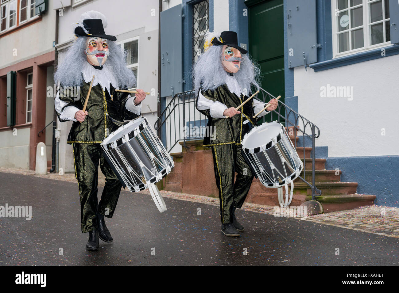 Many different groups of masked people walking through the streets of Basel, 3 days and nights, Basler Fasnacht, playing music Stock Photo