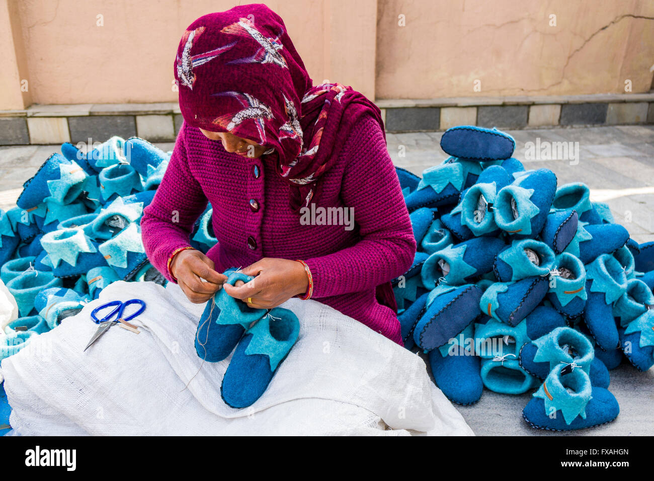 Woman working on felt shoes, Kathmandu, Kathmandu, Nepal Stock Photo