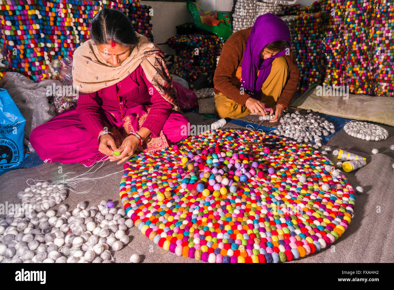 Women are producing a carpet from felt balls,, Kathmandu, Nepal Stock