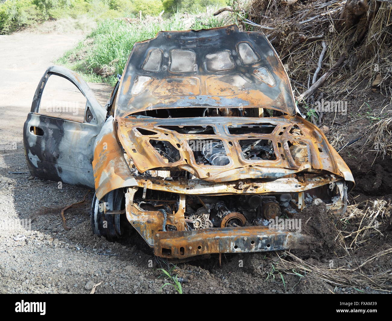 Burned out abandoned stolen Ford car from arson attack Stock Photo